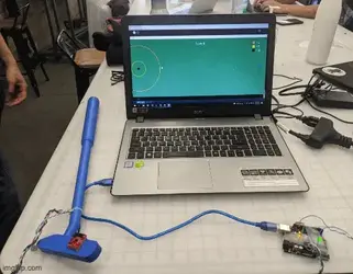 An animation of a haptic mini golf club and the final game setup on a laptop screen.